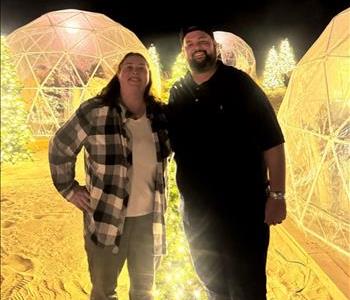 Servpro franchise owners with a christmas themed background