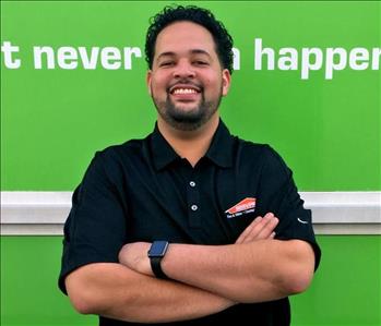 man in front of green wall