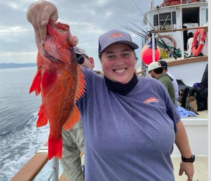 SERVPRO owner holding orange fish